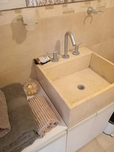 a sink in a bathroom with a counter top at Amplio departamento en Bv Galvez in Vuelta del Paraguayo