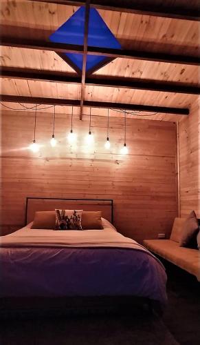 a bedroom with a large bed with a blue star above it at Biofilia Colombia in Tausa Viejo