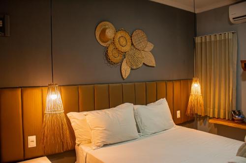 a bedroom with a bed with two lights on it at Pousada Villa Uçá Frances - Praia do Frances in Marechal Deodoro