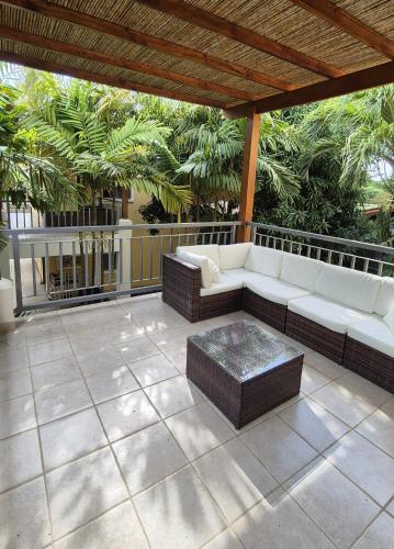 a patio with a white couch and a table at Iris Apartment in Potrero