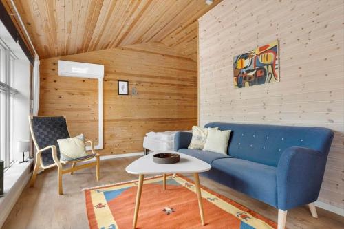 a living room with a blue couch and a table at 80182-Vemb-Ogelstrupvej-4 in Lillelund
