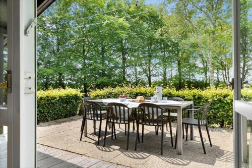 a white table and chairs on a patio at 80182-Vemb-Ogelstrupvej-4 in Lillelund