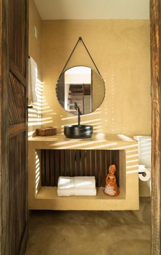 a bathroom with a sink and a mirror at Morro de São Paulo - Boho Loft Escape Pool Balcony & Champagne in Cairu