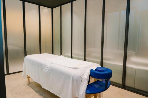 a hospital room with a table with a white blanket at Kondo Hotel Allure in Budva