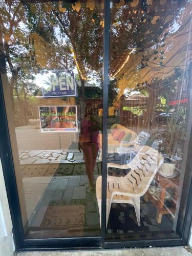 a woman walking through a window of a store at Massaji&SPA-Massage Spa in Oslob