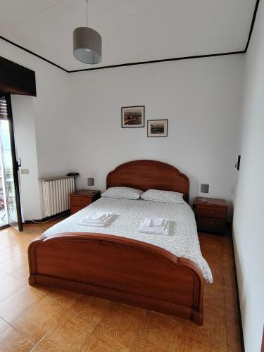 a bedroom with a large wooden bed in a room at Ca' d'Alfonso in Baveno