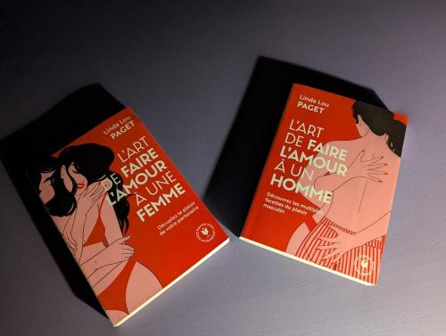 two books sitting next to each other on a table at Le Purple, love room centre ville avec parking in Montauban