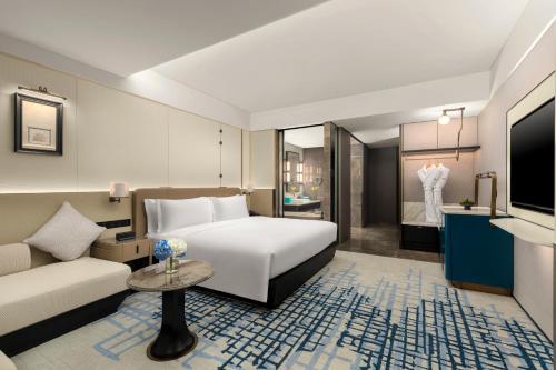 a hotel room with a bed and a couch at Crowne Plaza Beijing Tongzhou in Beijing