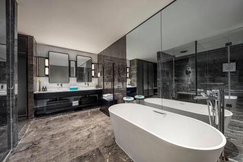 a large bathroom with a tub and two sinks at Crowne Plaza Beijing Tongzhou in Beijing