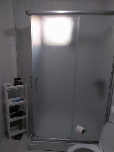 a bathroom with a shower stall with a toilet at Sorin Apartments Gevgelija in Gevgelija