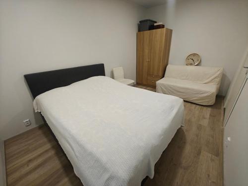 a bedroom with a white bed and a desk at Close to the Sea, Scandi Style house in Porvoo