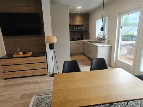 a kitchen with a table and chairs and a television at Close to the Sea, Scandi Style house in Porvoo