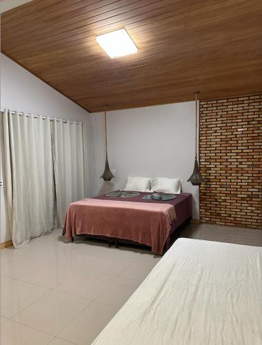 a bedroom with two beds and a ceiling at Chalé Iracema – Atins-MA in Atins