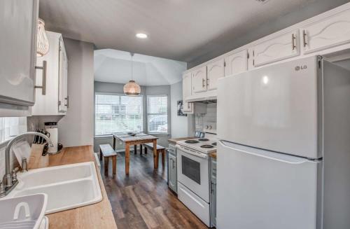 a kitchen with a white refrigerator and a table at Dedo Days Retreat in Bartlett