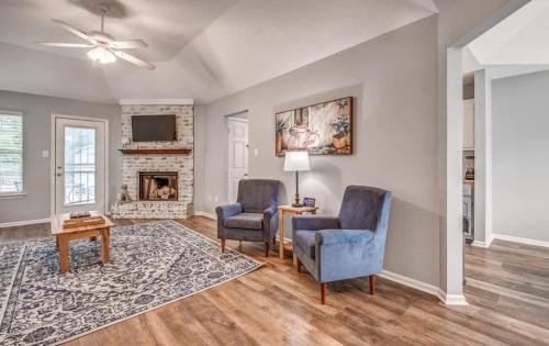 a living room with two chairs and a fireplace at Dedo Days Retreat in Bartlett