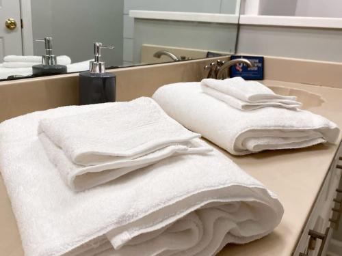 two stacks of towels sitting on a counter in a bathroom at Dedo Days Retreat in Bartlett
