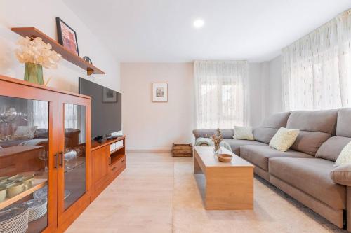 a living room with a couch and a tv at Apartamento Aires del Jiloca en Cella in Cella