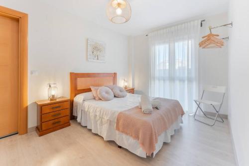 a bedroom with a bed with two pillows on it at Apartamento Aires del Jiloca en Cella in Cella