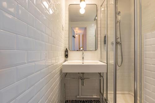 a white bathroom with a sink and a mirror at ibis Styles Paris Eiffel Cambronne in Paris