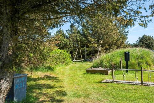 a park with a tree and a swing at 20863-Ulfborg-Sundhuse-19-A in Vedersø Klit