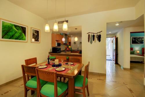 a kitchen and dining room with a table and chairs at Palmar del Sol by Riviera Maya Suites in Playa del Carmen