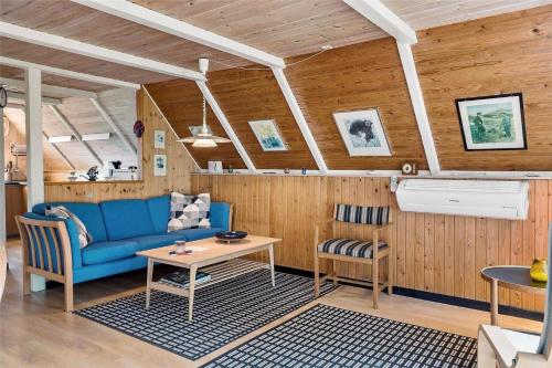 a living room with a blue couch and a table at 20398-Ulfborg-Hummelmosevej-7 in Sundhuse