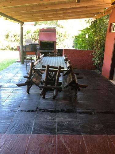 a picnic table on a patio with a grill at El milagro in La Reja