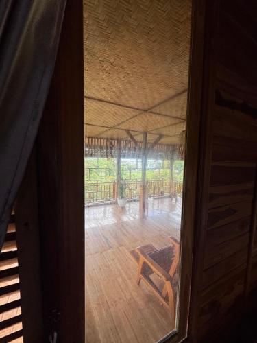 an open door to a room with a wooden floor at Pesona 361 Alam Bungalows in Rarang