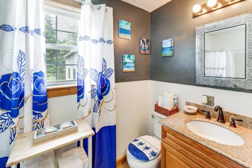 a bathroom with a sink and a toilet and a mirror at Family-Friendly Home with Furnish Patio in Crystal! in Island Falls