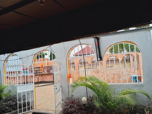 a building with three gates and a courtyard with plants at HOTEL Zero6 in Voi