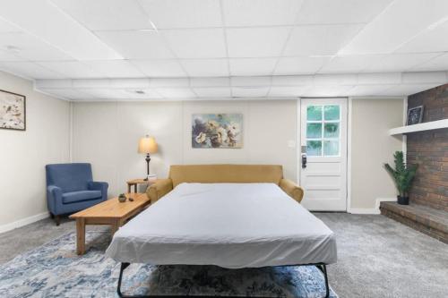 a bedroom with a bed and a table and a couch at Miami Family Friendly in Forestdale in Owenton