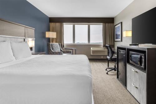 a hotel room with a bed and a desk at Best Western Plus Chocolate Lake Hotel - Halifax in Halifax