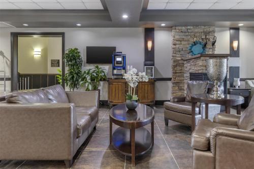 a waiting room with couches and a fireplace at Best Western Plus Chocolate Lake Hotel - Halifax in Halifax
