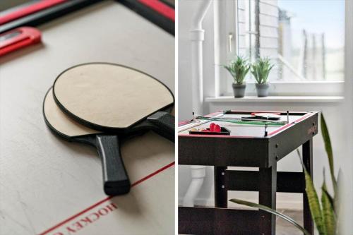 a tennis racket hanging on a wall next to a table at 70181-Ulfborg-Enghavevej-2 in Thorsminde
