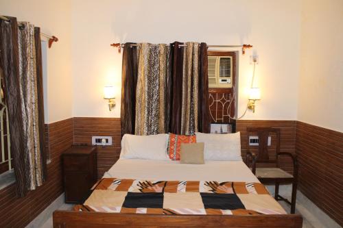 a bedroom with a bed and a window at Kolkata Vintage Stay - 2BHK with Bengali Home Vibe in Kolkata