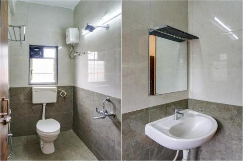 a bathroom with a sink and a toilet and a mirror at Collection O Golden Leaf in Pune