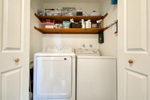 a small laundry room with a washer and dryer at Bluejay Hideaway by Tahoe Getaways - Kings Beach 3 BR Pet Friendly w Enclosed Yard and Hot Tub in Brockway Vista