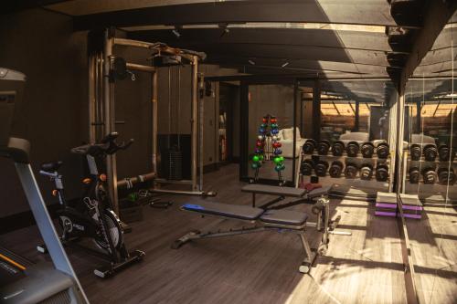 a gym with bikes and exercise equipment in it at Pousada Murano in Campos do Jordão