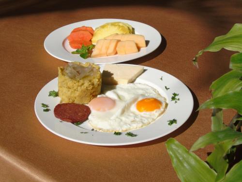 two plates of breakfast foods on a table at Piergiorgio Palace Hotel in Sosúa
