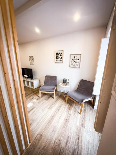 a living room with two chairs and a table at Seaside Studio - Cascais historic centre in Cascais