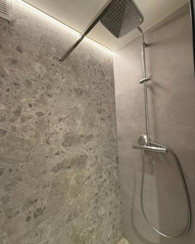 a shower with a shower head in a bathroom at Casa Del Sol Pietra Kotor in Kotor