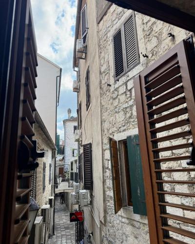 an alley in an old town with a building at Casa Del Sol Pietra Kotor in Kotor