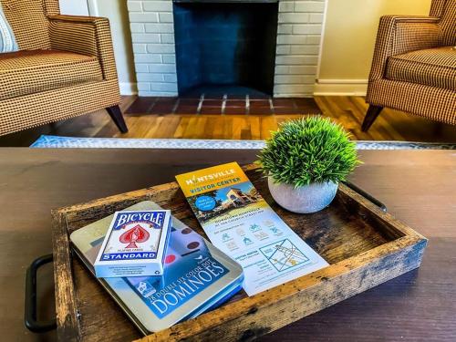 a coffee table with books and a plant on it at Bonita Bungalow in Huntsville