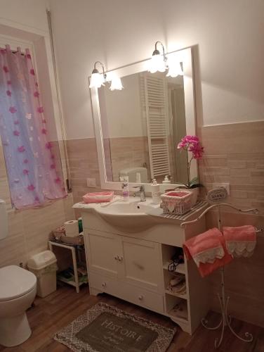 a bathroom with a sink and a mirror and a toilet at Roses House in Sestri Levante