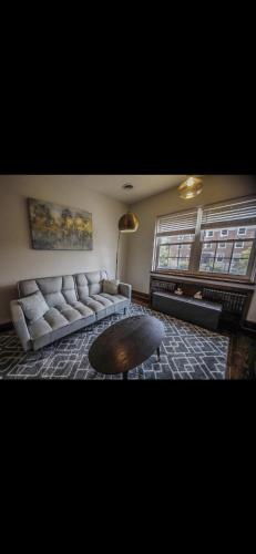 a living room with a couch and a coffee table at Boone Trace Inn Room 5 in Pineville