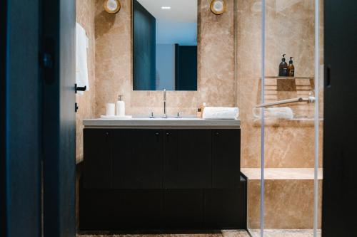 a bathroom with a sink and a mirror at Kondo Hotel Allure in Budva