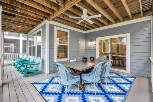 a dining room with a table and chairs on a porch at 28 Hammock Breeze Way in Hilton Head Island