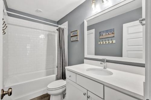 a white bathroom with a sink and a toilet at 28 Hammock Breeze Way in Hilton Head Island