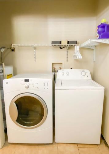a white washer and dryer in a laundry room at Bonita Bungalow in Huntsville