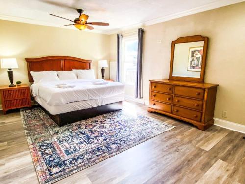 a bedroom with a bed and a mirror and a dresser at Bonita Bungalow in Huntsville